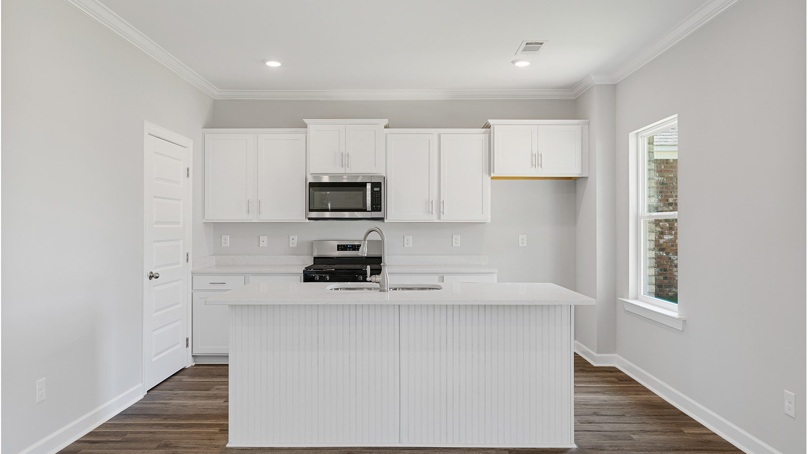 luxury vinyl plank flooring in kitchen with stainless steel appliances and Quartz countertops with soft close cabinets