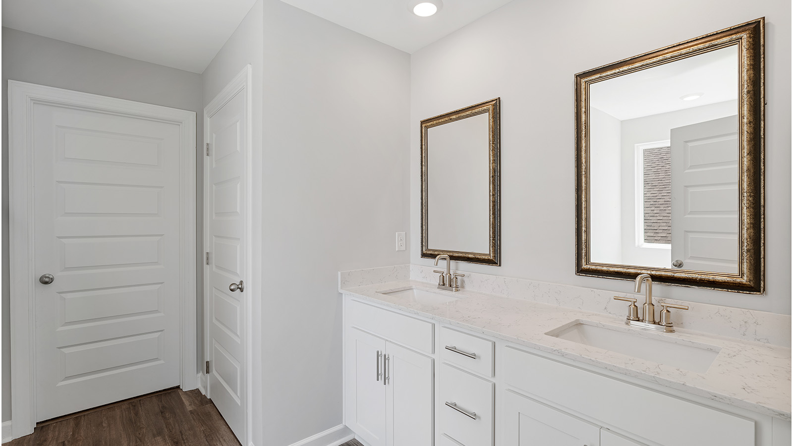 luxury vinyl plan flooring in bathrooms with quartz countertops