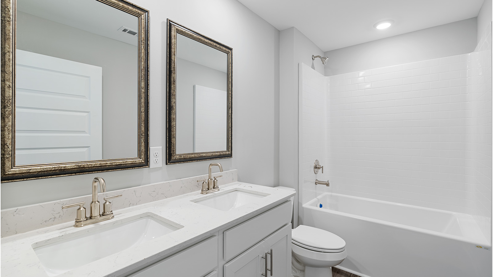 luxury vinyl plan flooring in bathrooms with quartz countertops