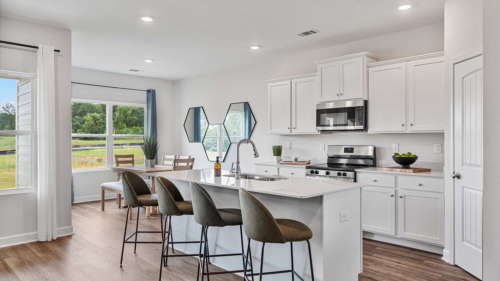 luxury vinyl plank flooring in kitchen with stainless steel appliances and Quartz countertops with soft close cabinets