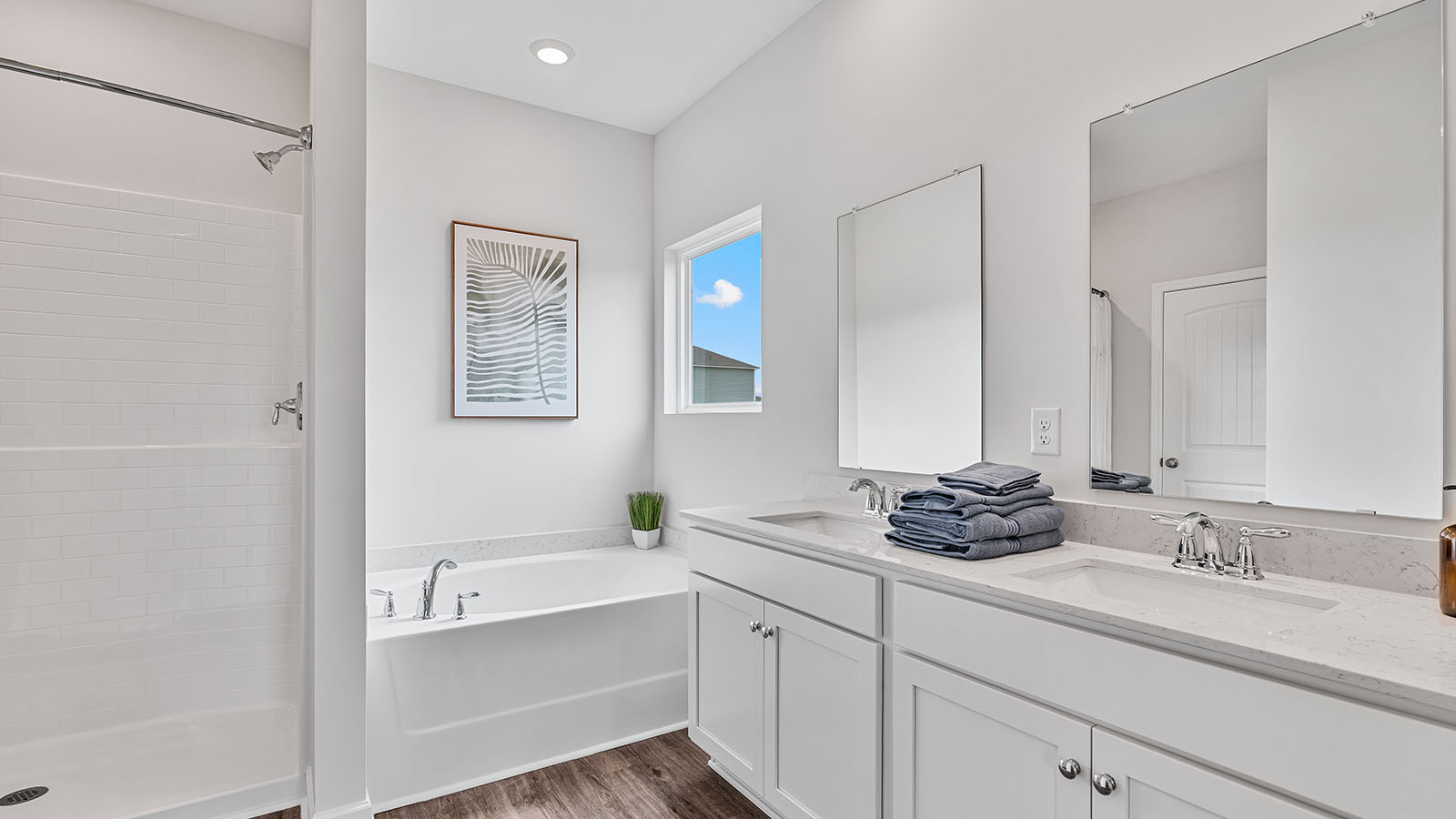 luxury vinyl plan flooring in bathrooms with quartz countertops