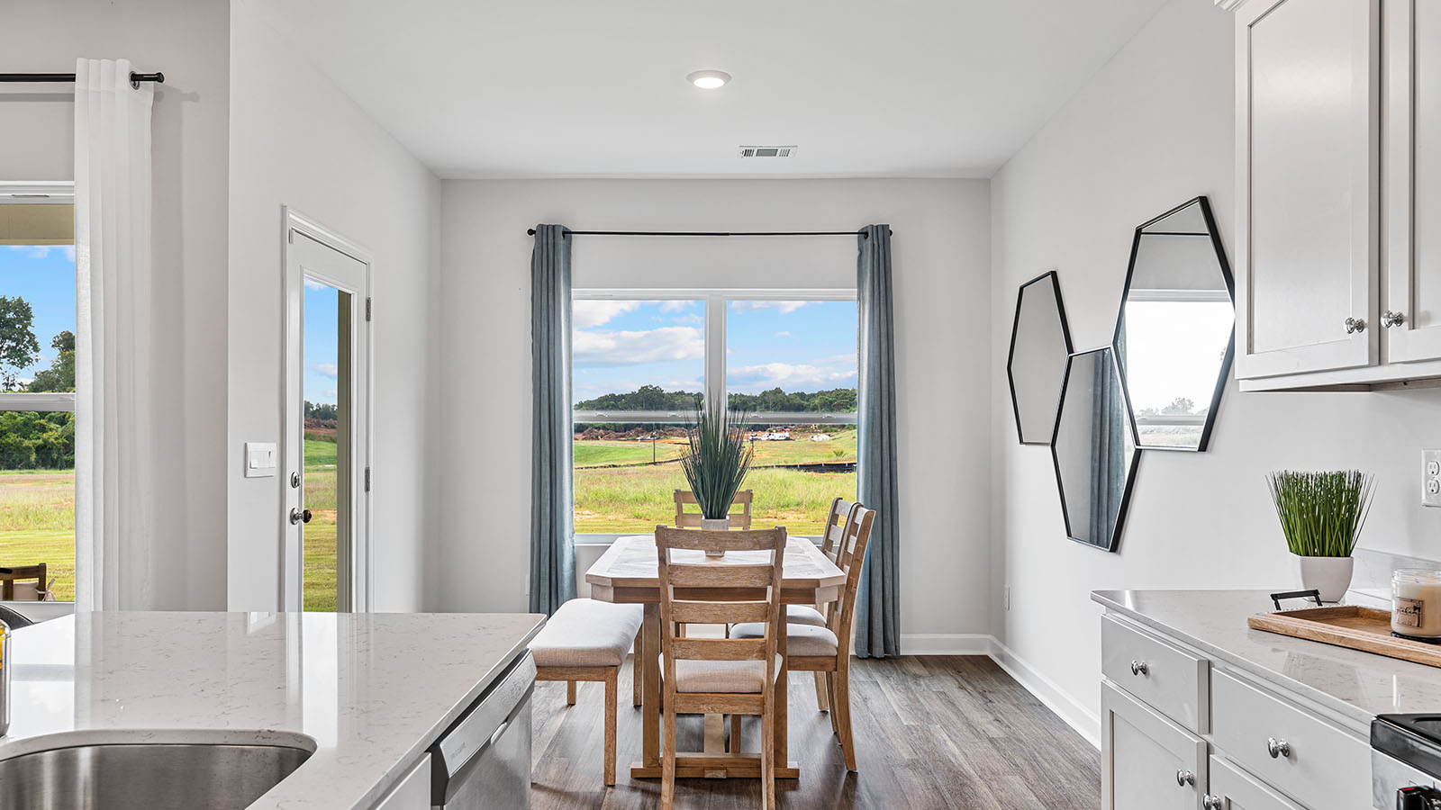 luxury vinyl plank flooring in kitchen with stainless steel appliances and Quartz countertops with soft close cabinets