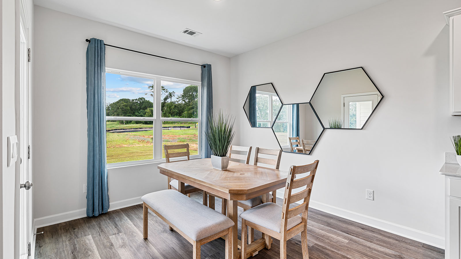 luxury vinyl plank flooring in kitchen with stainless steel appliances and Quartz countertops with soft close cabinets