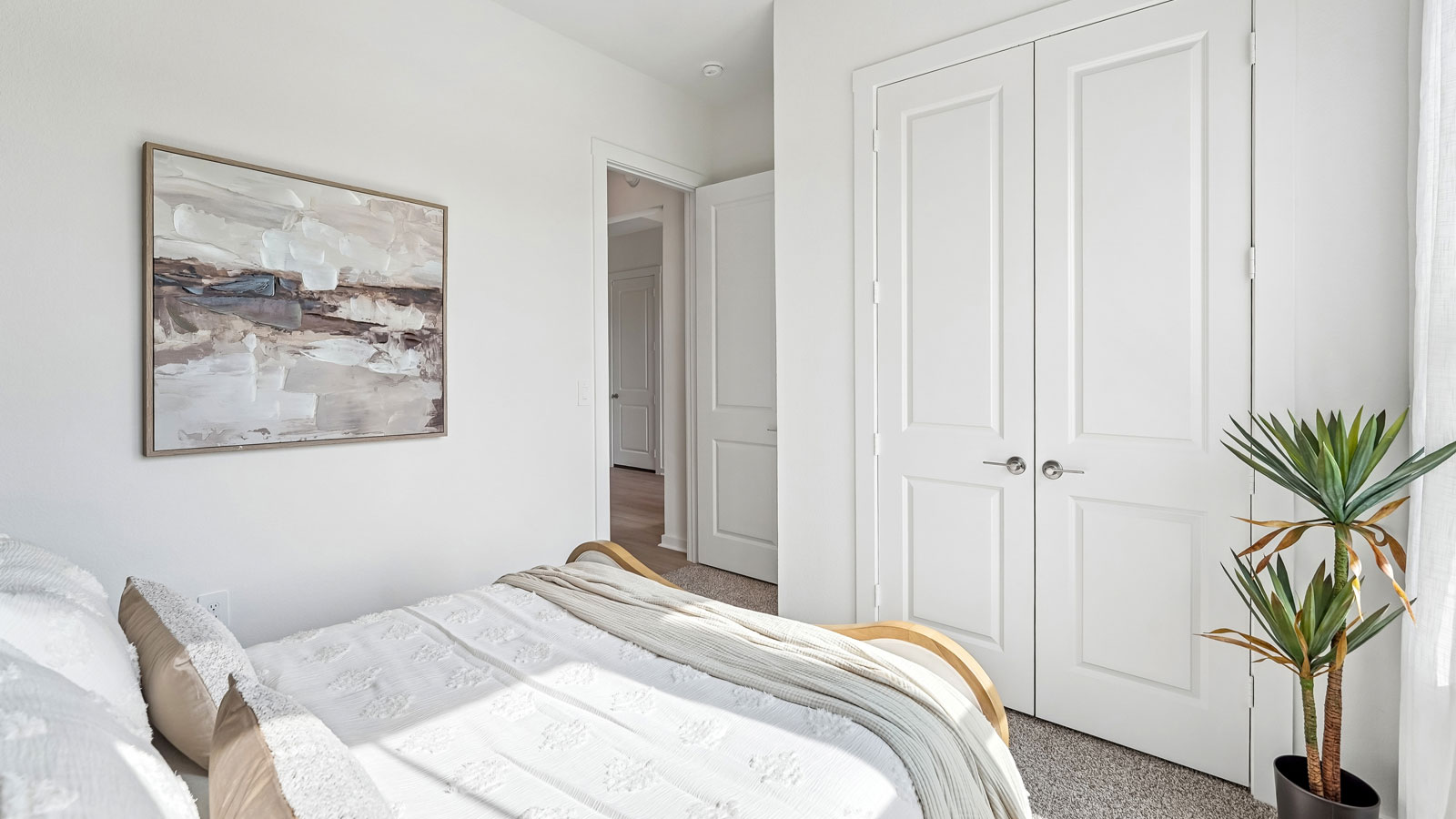 Bedroom 2 with carpeted flooring and closet.