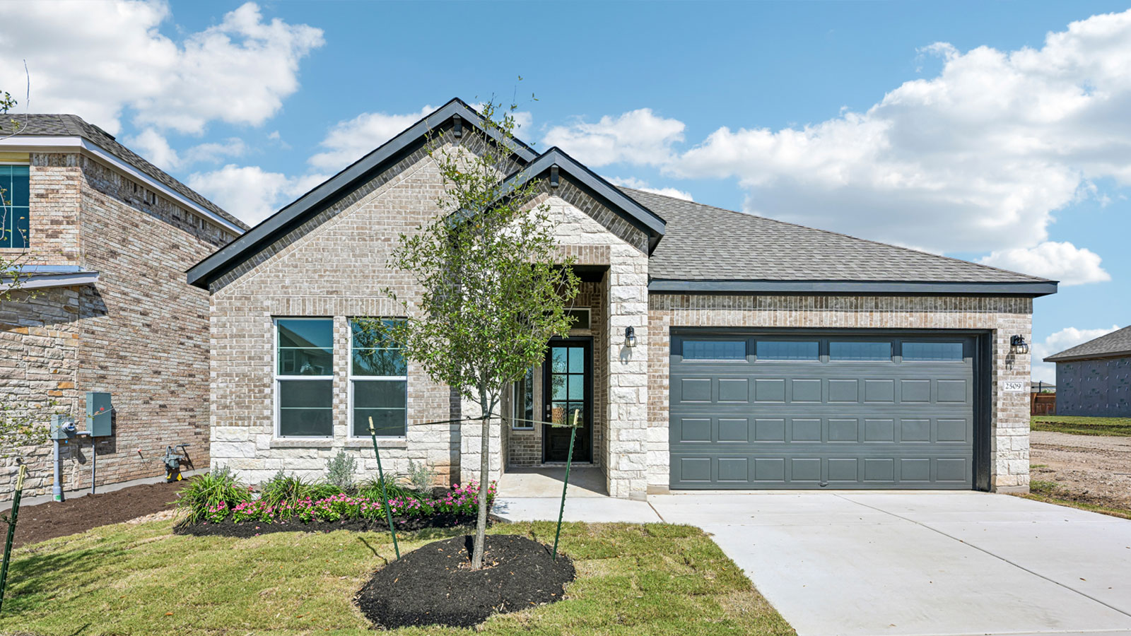 The Edinburg floorplan - Y Elevation at the Enclave at Bar W Ranch in Leander, TX.