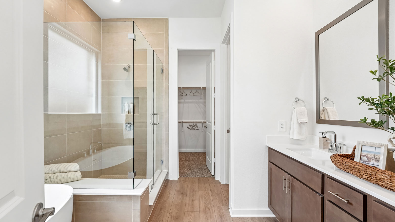 Main bathroom with frameless shower and stand alone bathtub.