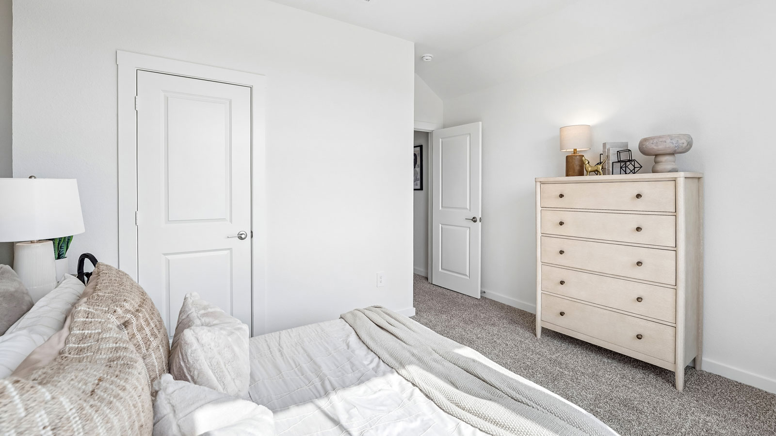 Bedroom 4 with two large windows, carpeted flooring and closet.