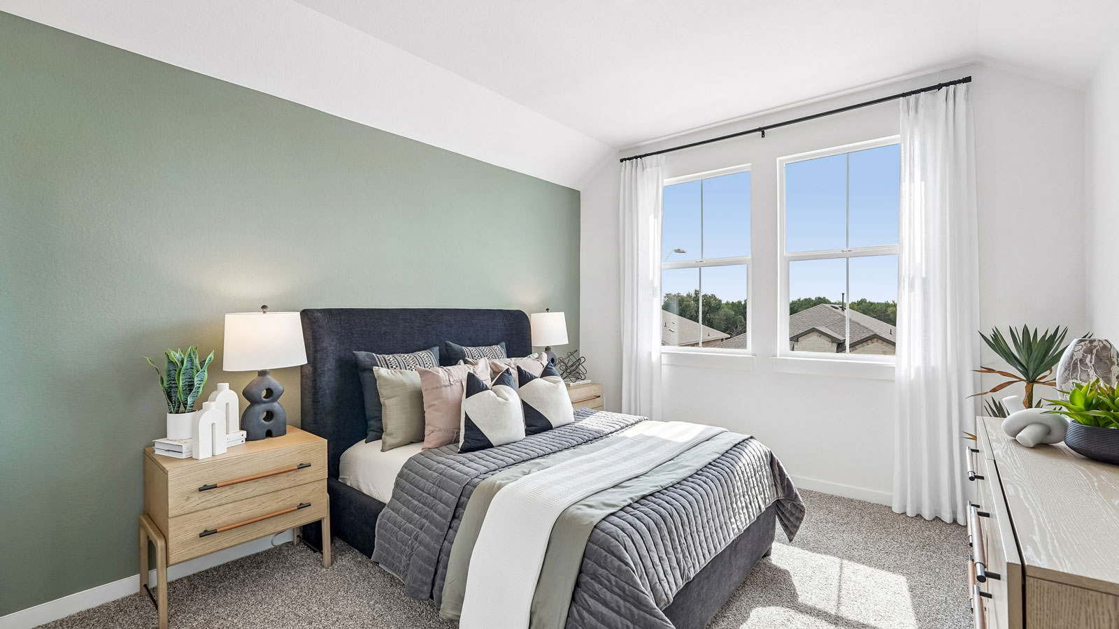 Bedroom 3 with two large windows, carpeted flooring and closet.