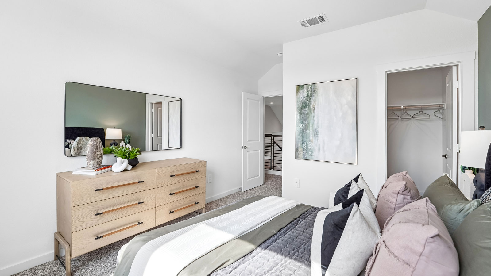 Bedroom 3 with two large windows, carpeted flooring and closet.
