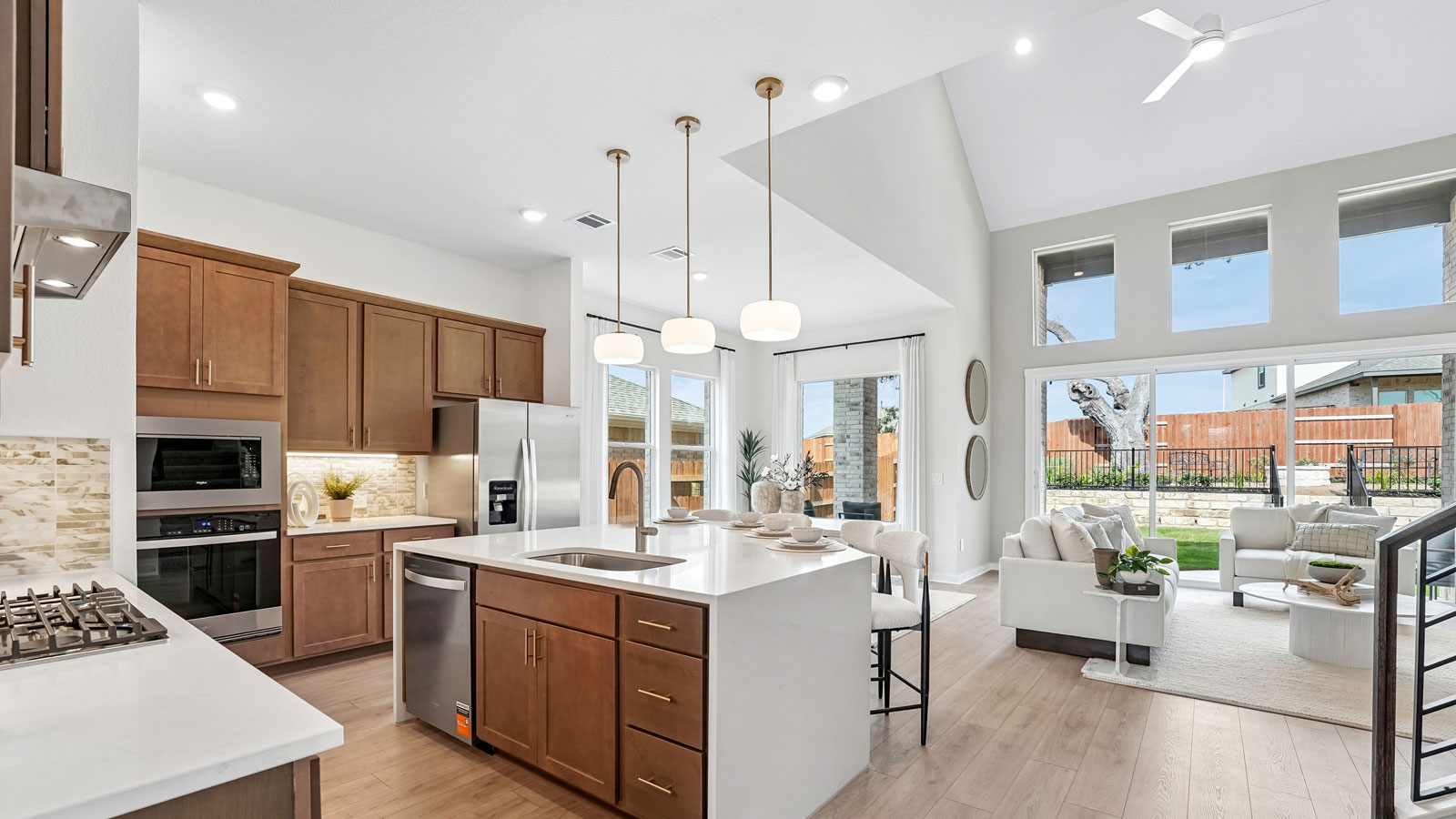 Luxurious kitchen with waterfall island and elegant pendant lights.