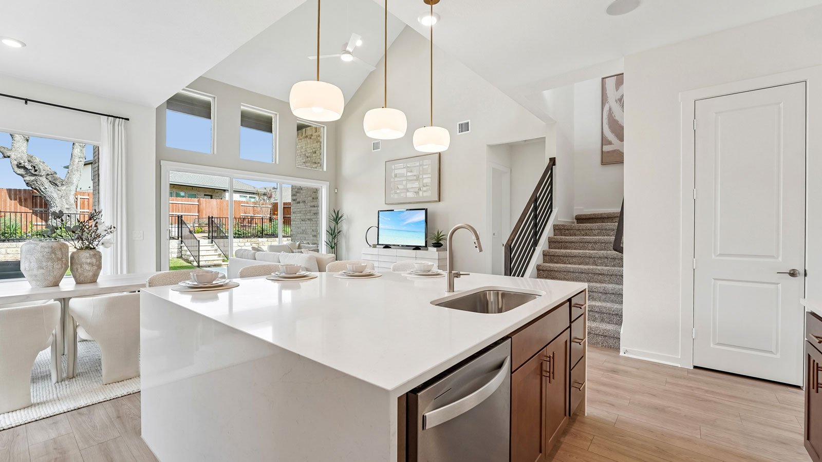Luxurious kitchen with waterfall island and elegant pendant lights.
