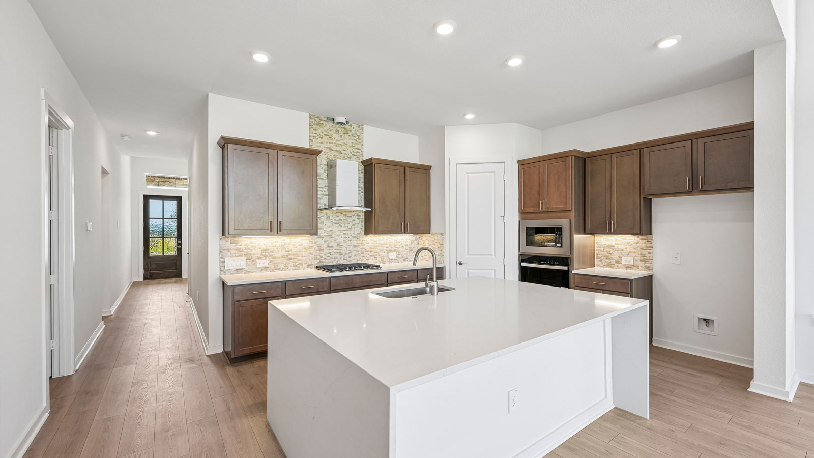 Chef's kitchen with quartz waterfall kitchen island.