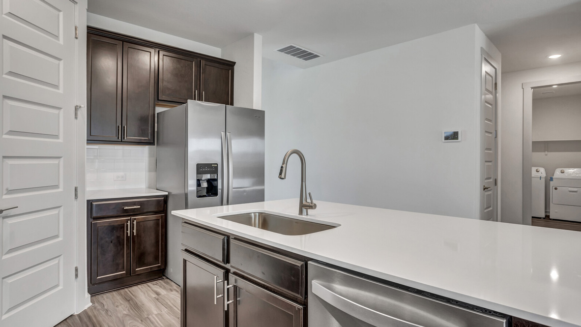 Kitchen featuring brown cabinets, stainless steel appliances, and a large island.