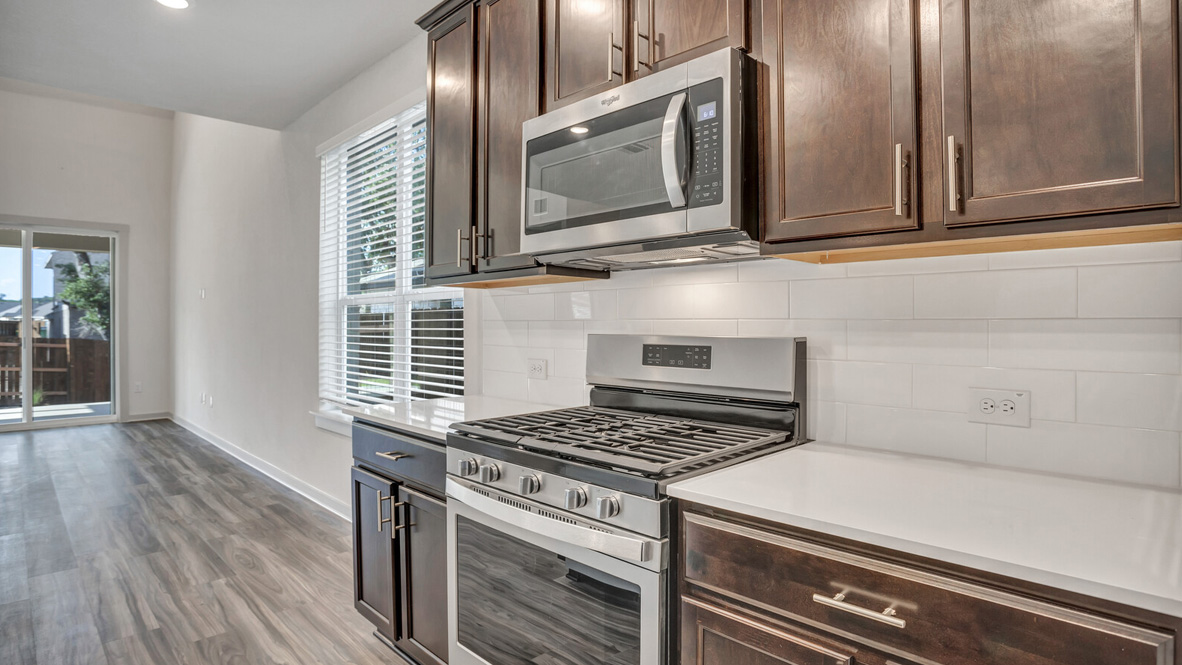 Kitchen featuring brown cabinets, stainless steel appliances, and white countertops.