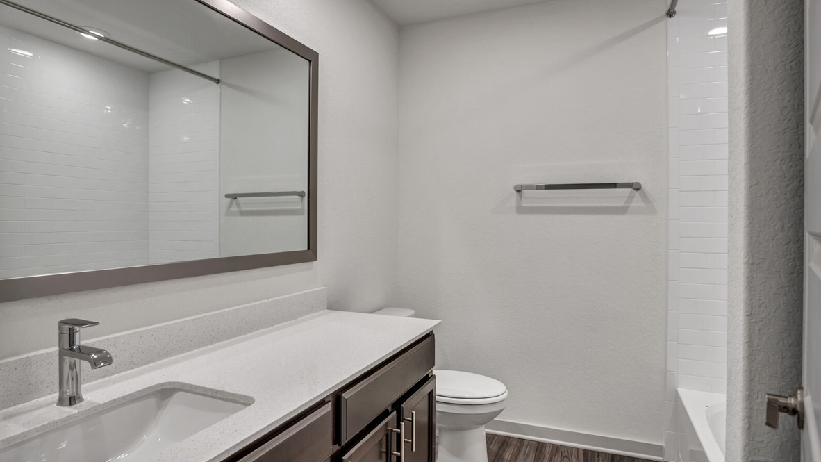 Bathroom with a sink, toilet, and shower.