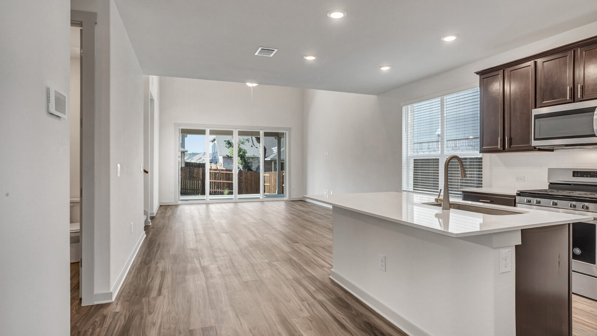 Kitchen featuring brown cabinets, stainless steel appliances, and a large island.
