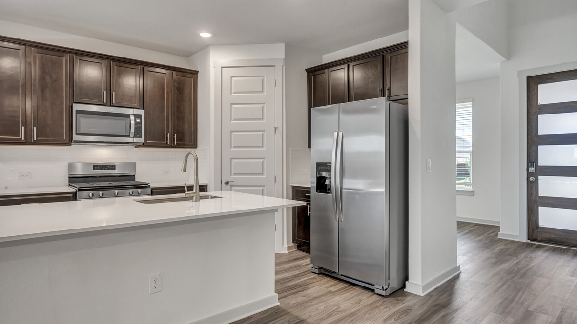 Kitchen featuring brown cabinets, stainless steel appliances, and a large island.