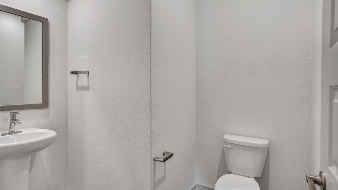 Powder bath with a sink and toilet.