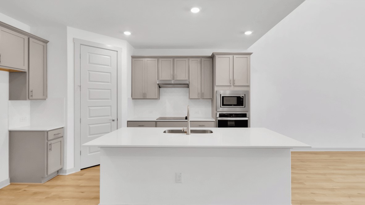 Open-concept kitchen with island, stainless steel refrigerator, and family room view at Thunder Rock