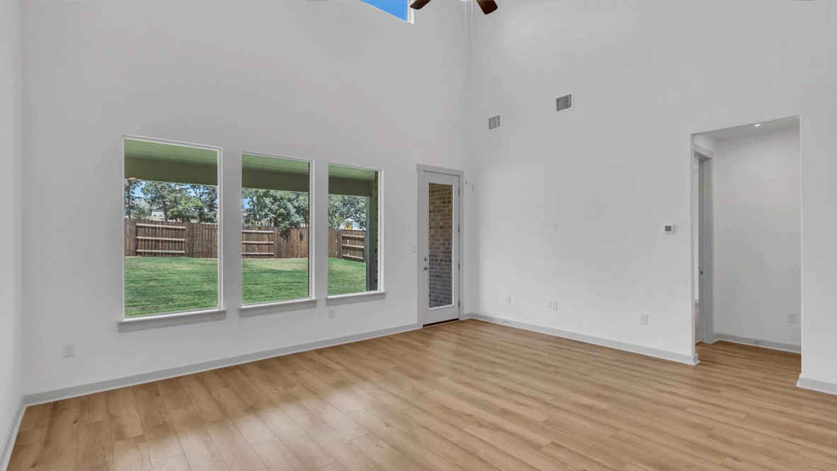 Kitchen and family room combination with hard surface countertops and stairway backdrop in Thunder Rock