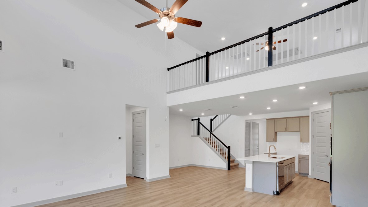 Two-story living room at the front of Thunder Rock home off the main entryway by D.R. Horton
