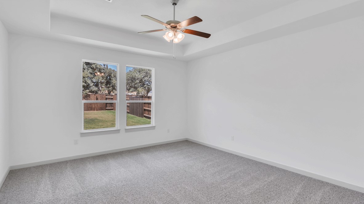 Secondary Bedroom in this Thunder Rock home showcases plush flooring, single door closet, and convenient hallway access.