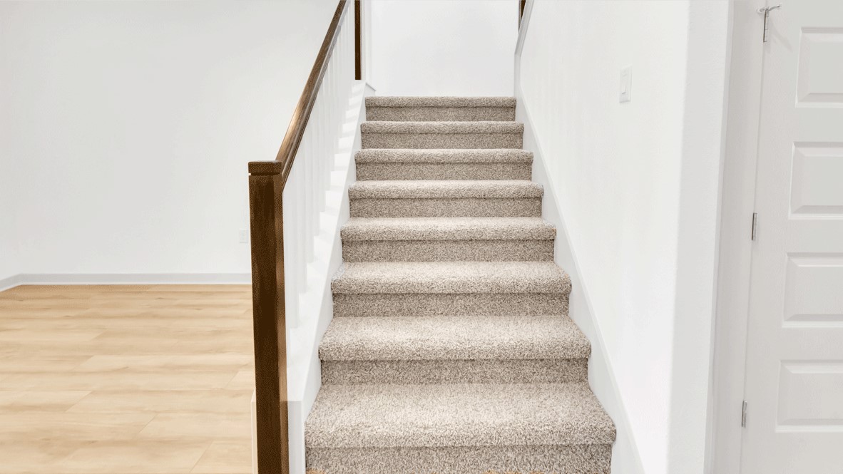 Upstairs loft space with carpeted floors and entrance to linen closet and bathroom