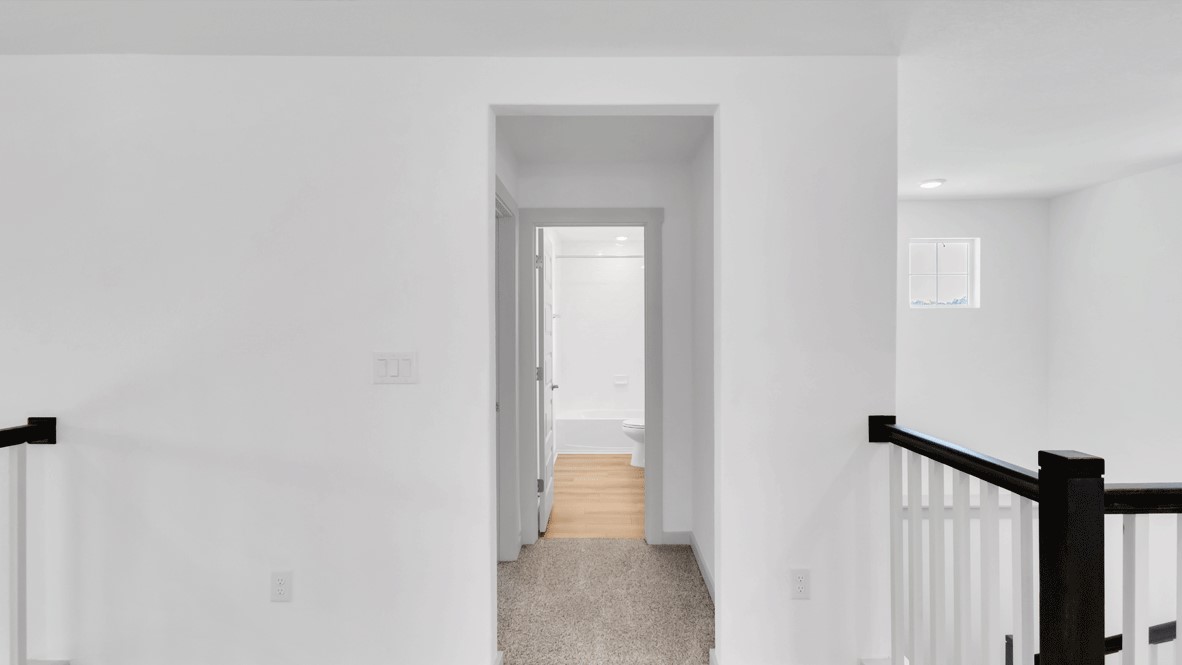 Upstairs hallway in new D.R. Horton home functioning as a connector between shared and private spaces