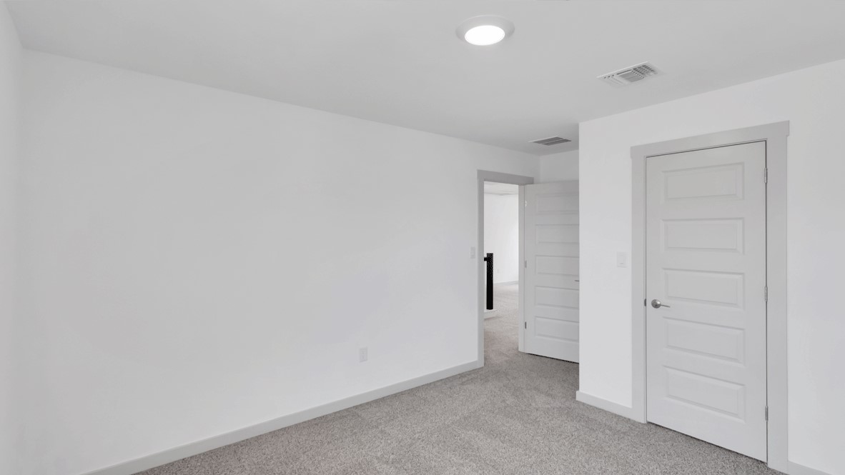 Owner’s suite offers natural light, neutral tones, and walk-in closet access for everyday comfort.