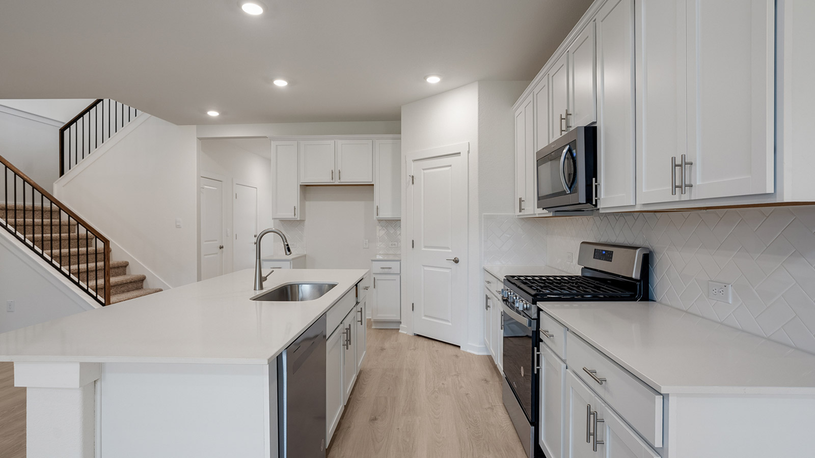 Kitchen with silestone countertops, stainless steel appliances, and decorative backsplash.
