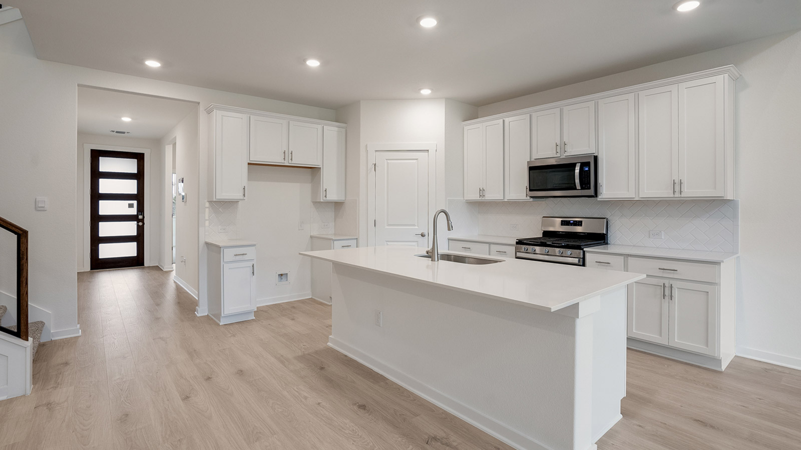 Kitchen with silestone countertops, stainless steel appliances, and decorative backsplash.