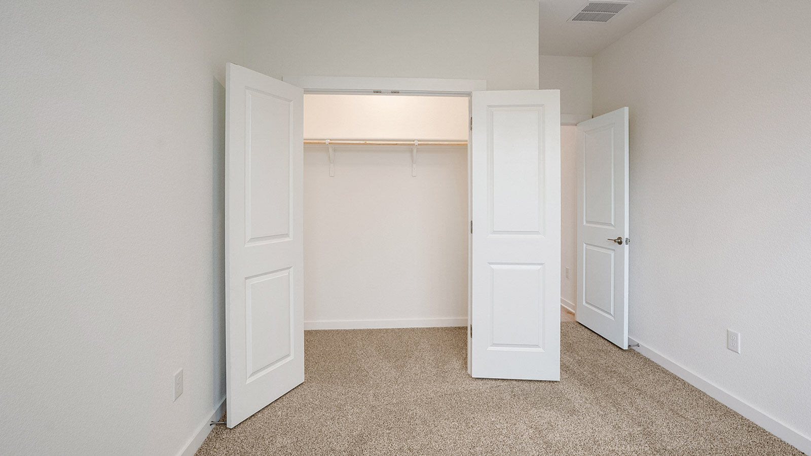 Bedroom 2 with carpeted flooring.