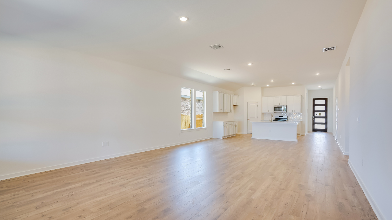 Living room perspective highlighting connectivity to dining and kitchen zones
