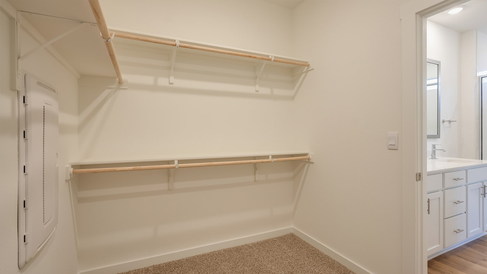 Interior view of the walk-in closet inside the owner's suite offering organized storage Rosenbusch Ranch