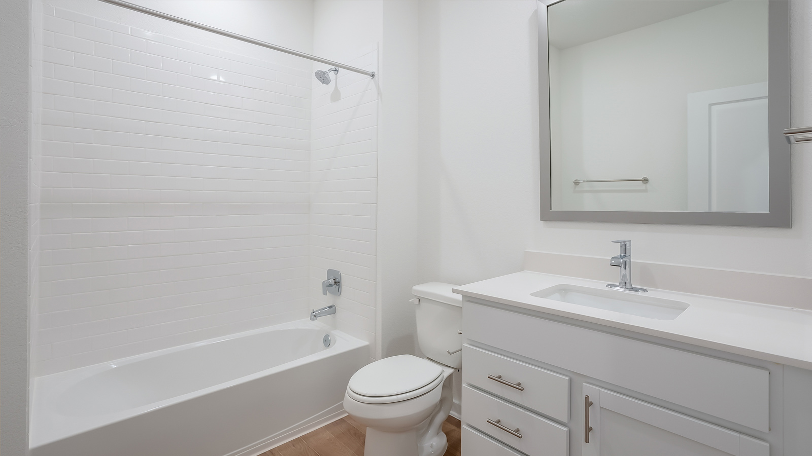 Family full bathroom with vanity, mirror, cabinets, and tub-shower combination Rosenbusch Ranch