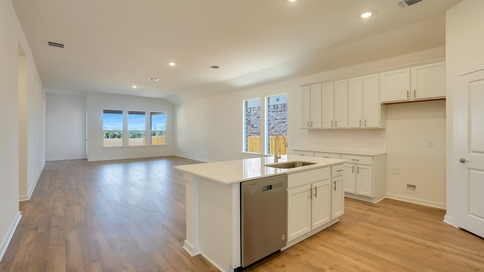 Kitchen featuring a new appliance suite included with cabinetry, prep space, and pantry access
