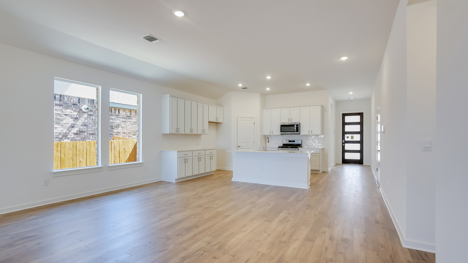 Open living room with laminated wood flooring.