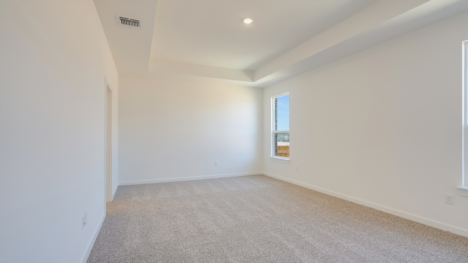 Main bedroom, bedroom 1, with carpeted floor.