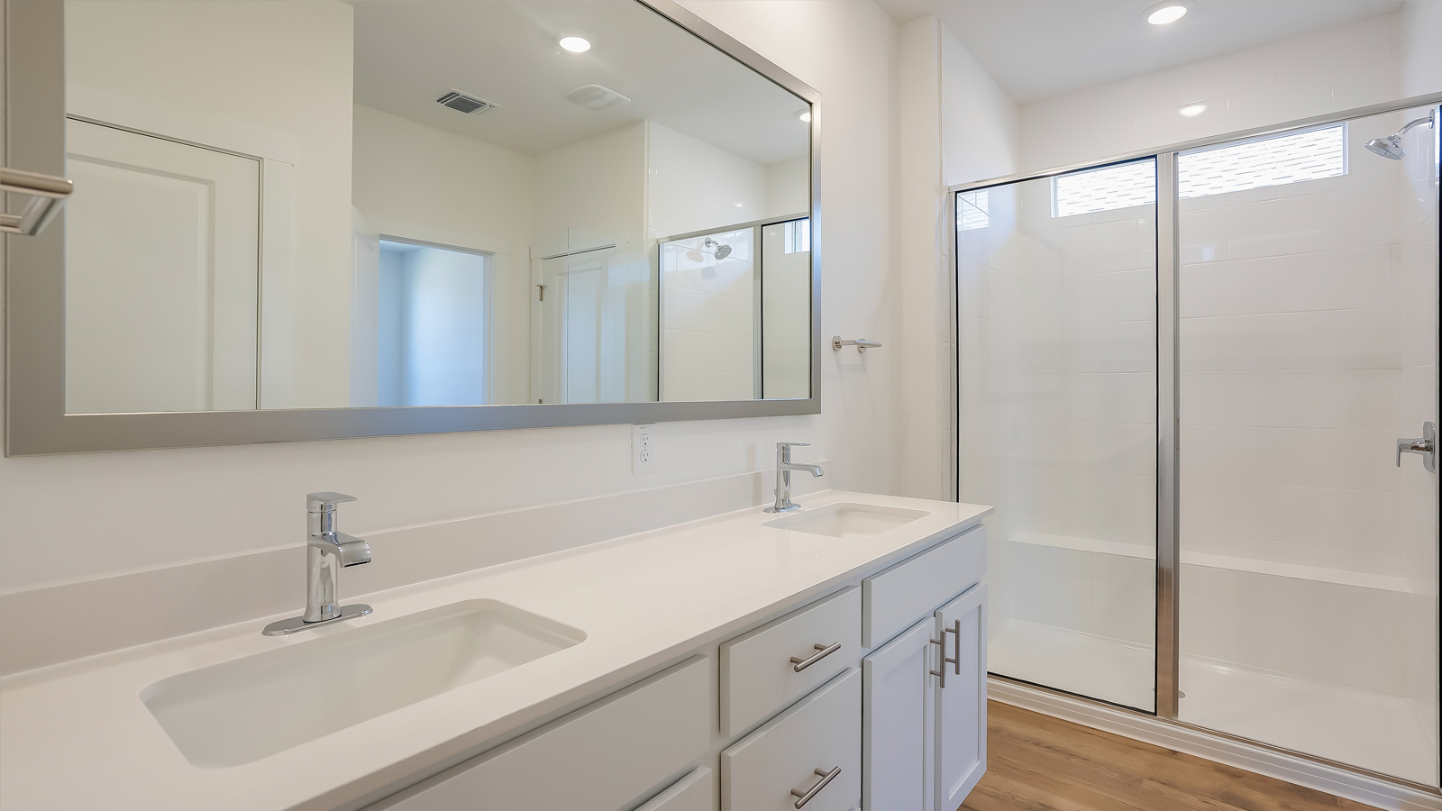 Bathroom sinks and walk-in shower.