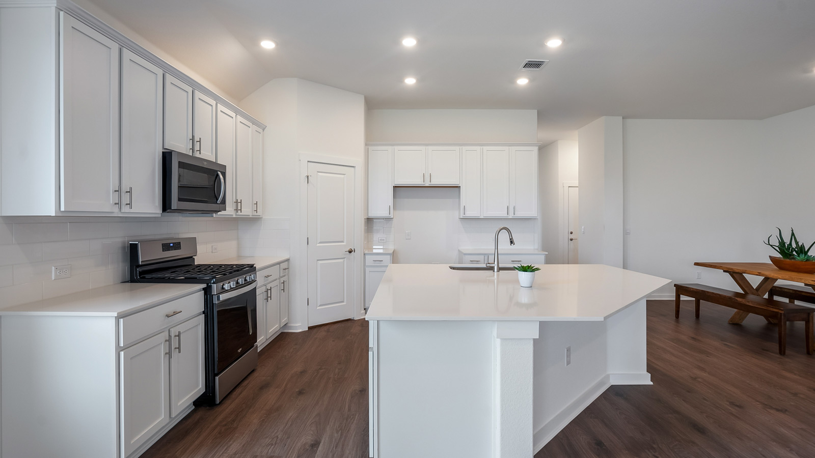 Gourmet kitchen with stainless steel appliances and quartz countertops.