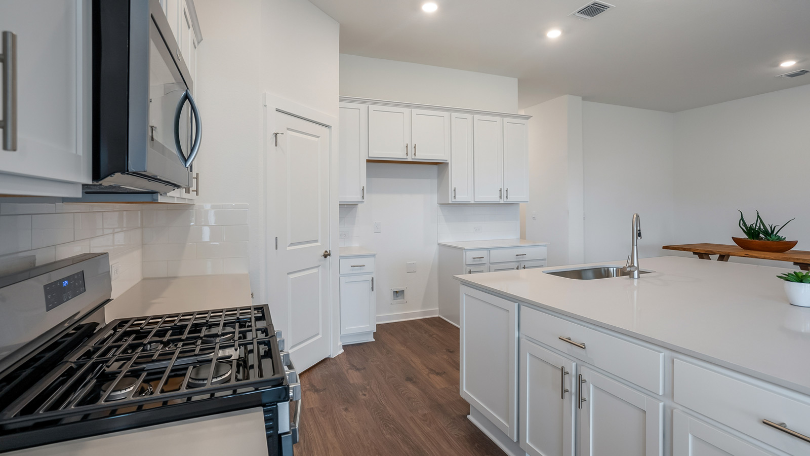 Gourmet kitchen with stainless steel appliances and quartz countertops.