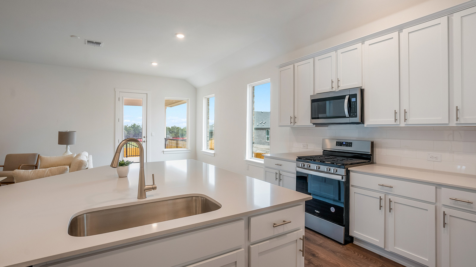 Oversized kitchen island with single bowl undermount sink.