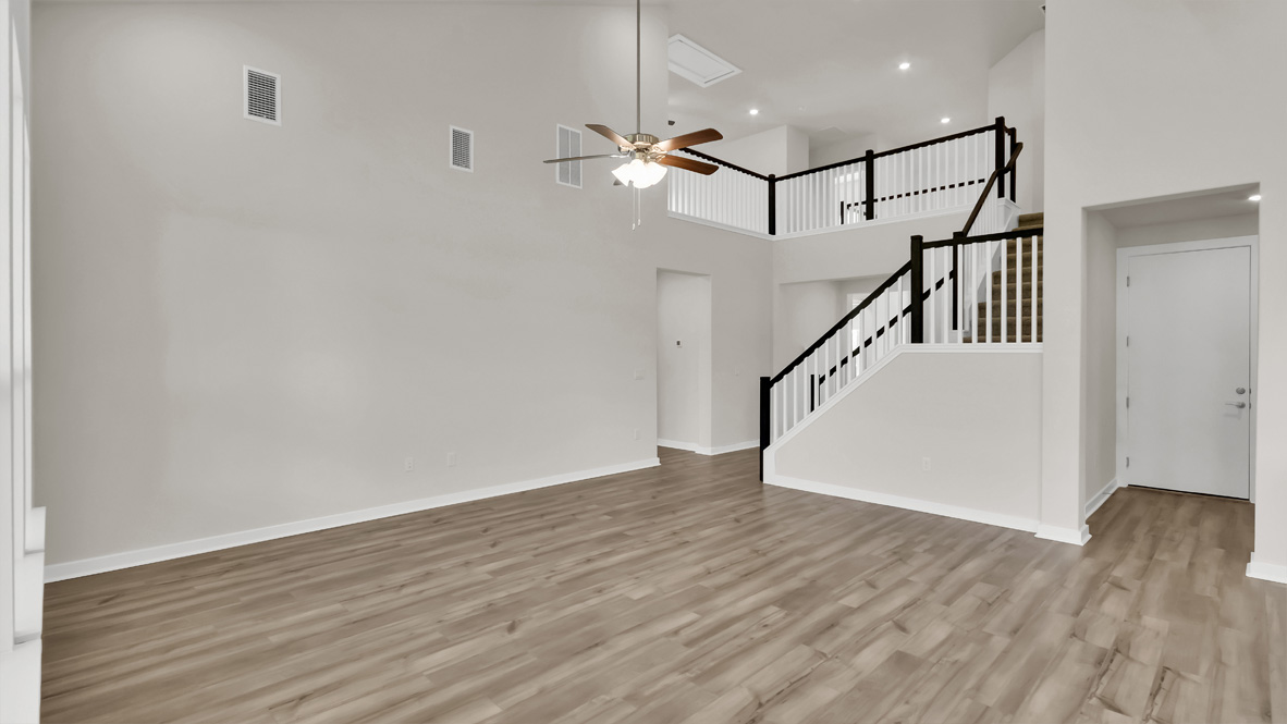 Functional layout with living room looking into modern kitchen and stairwell to upper bedrooms at Rosenbusch Ranch