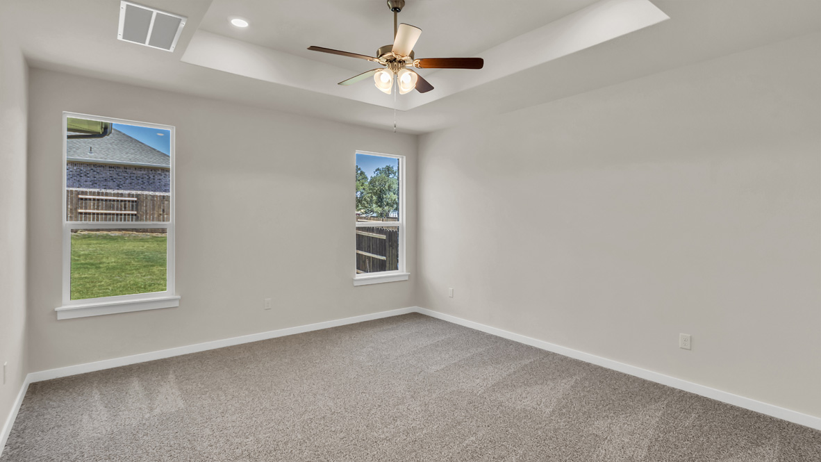 Owner’s suite offers natural window light, spa-inspired ensuite bathroom, backyard view, walk-in closet for everyday style