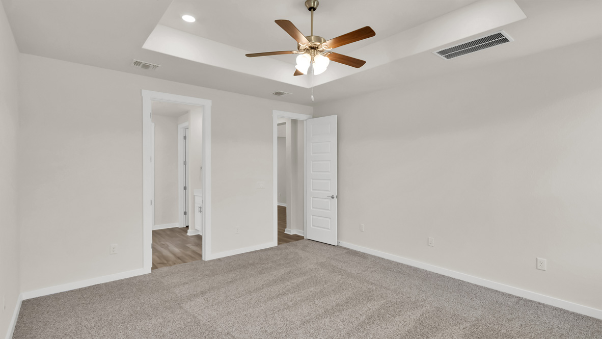 Primary bedroom features ample space, double windows, soft carpet, a stylish walk-in closet, and a private ensuite bath