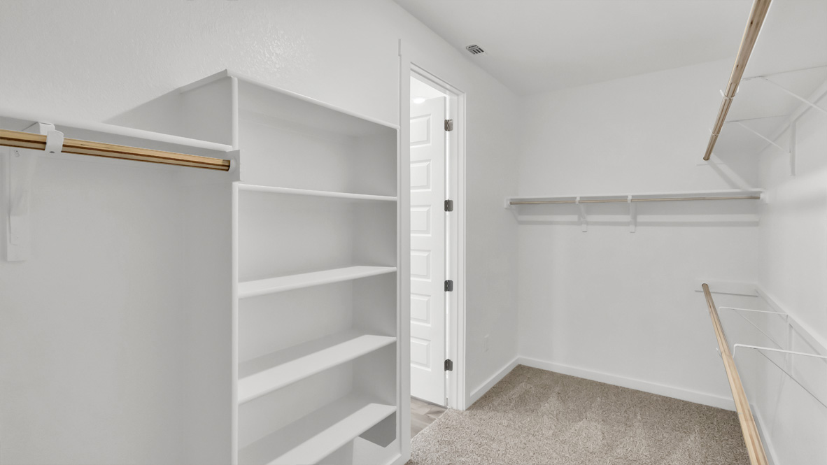 Primary suite walk-in closet in Rosenbusch Ranch  new home with built-in shelving and generous storage