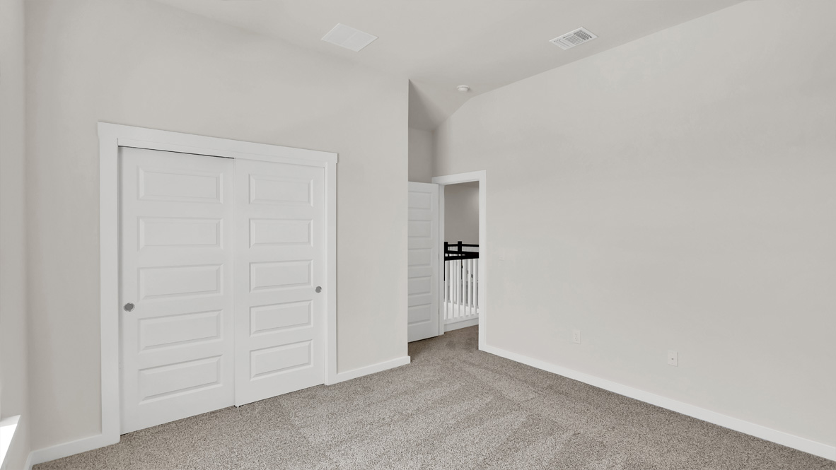 Second bedroom in Rosenbusch Ranch includes natural window light, full closet, connectivity to the residence