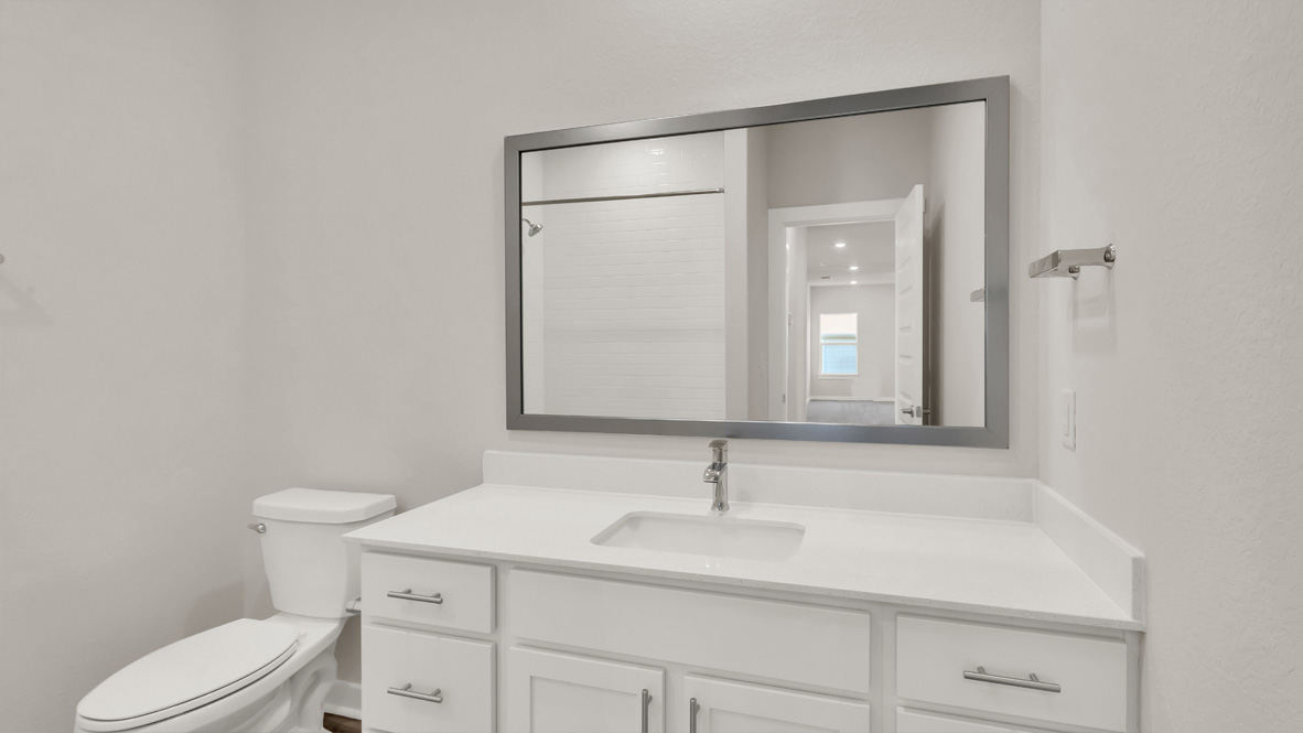 Sleek family-guest bath with single sink, mirror, cabinets, and shower-tub combination at Rosenbusch Ranch