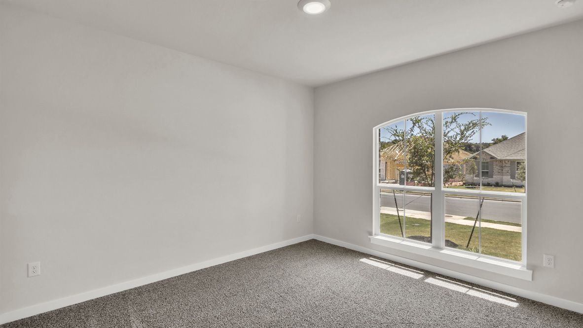 Second bedroom in Rosenbusch Ranch  showcases soft carpet, a single closet, soft window light, multi-use potential