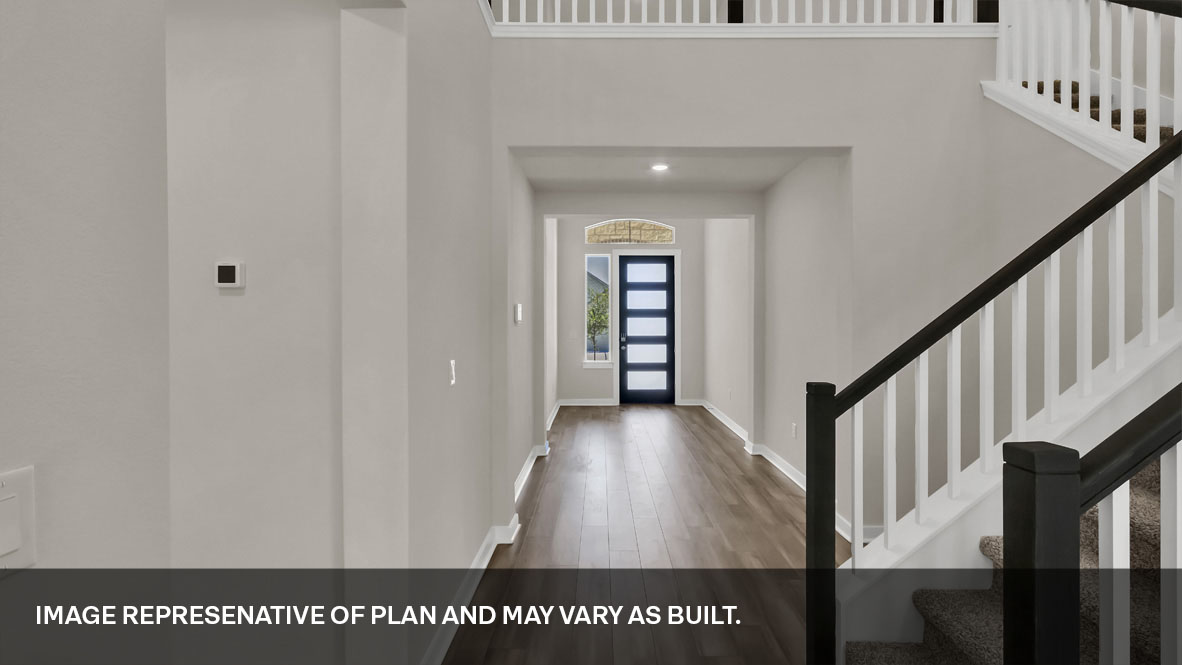 Entryway with view of stairs and front door.